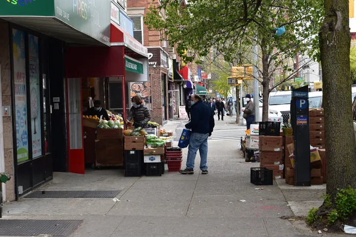 Shoppers picking fruit at a sidewalk stand in Bay Ridge, Brooklyn